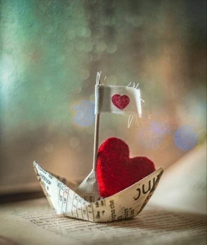 heart in newspaper boat.jpg