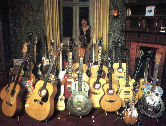 G Harrison with guitars.jpg