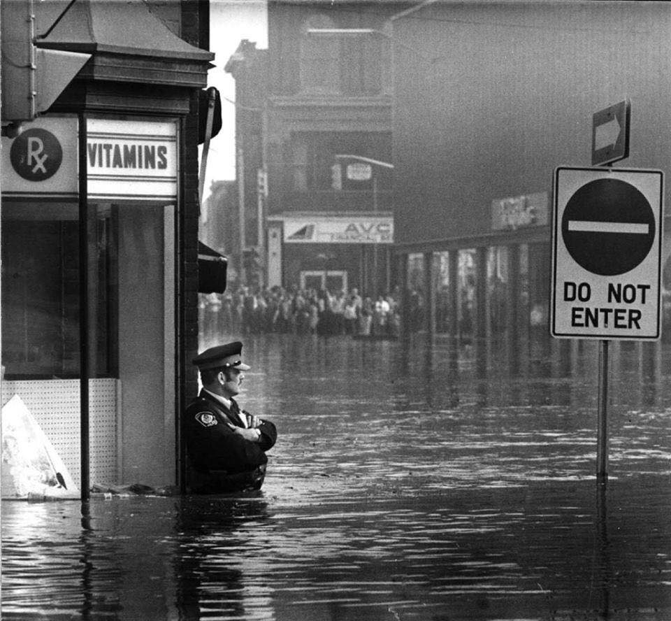 guarding a pharmacy in high-flood waters, Ontario, 1974.jpg